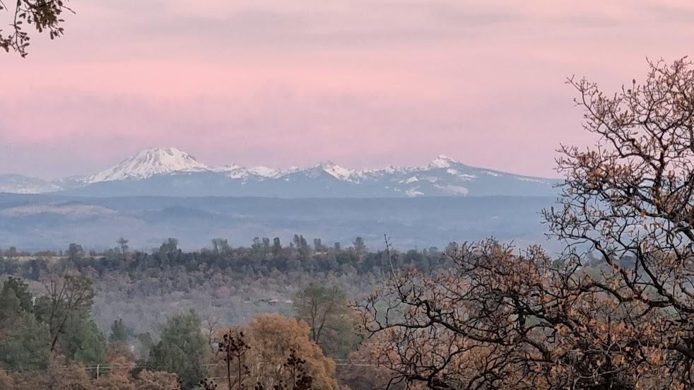 Snow-capped mountains at dusk where heaven meets earth