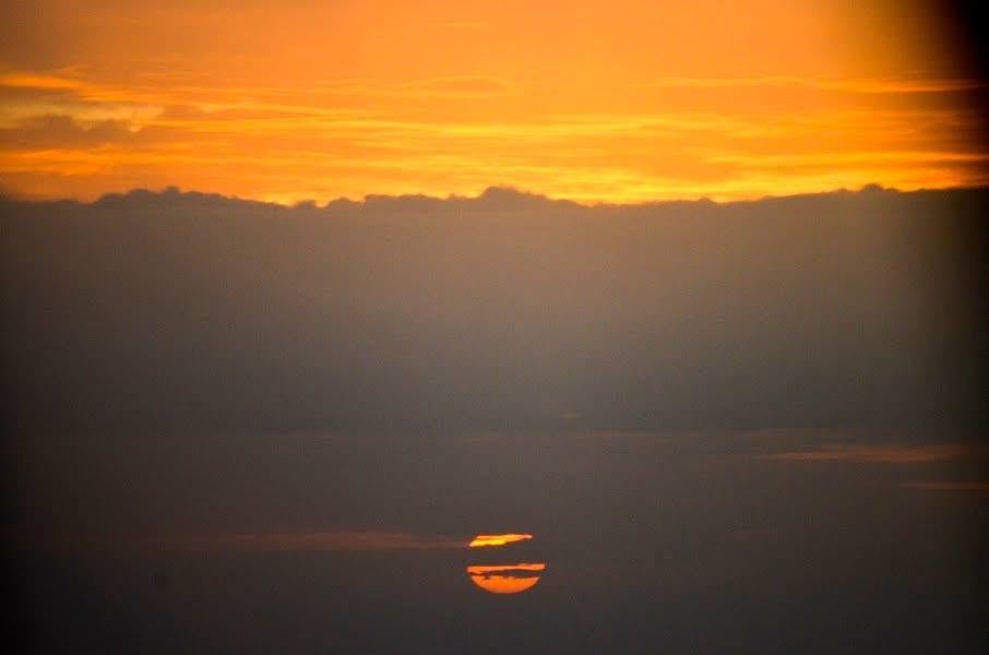 Sunset over the sea, where heaven kisses earth
